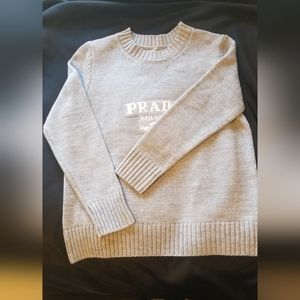 Grey women sweater unbranded that says Prada Milano.  S/M.